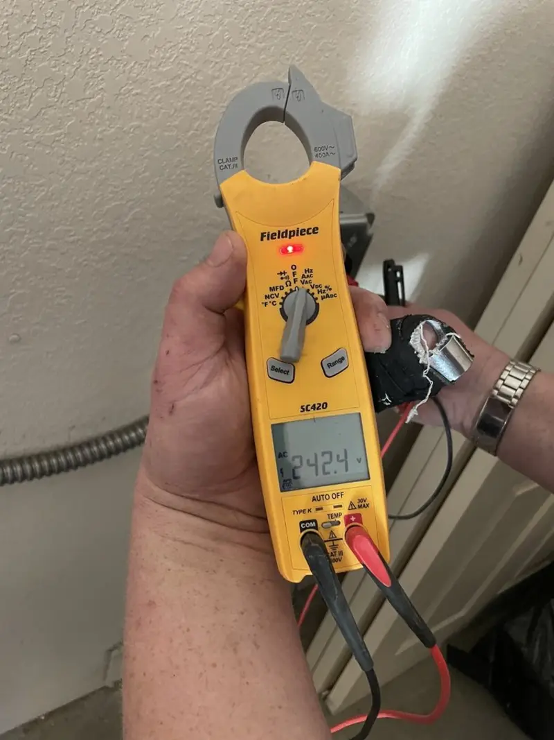 Voltage testing with clamp meter during Recessed Lighting Installation in Ennis